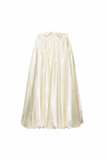 Off-white women’s midi skirt with balloon shape, hidden in-seam pockets, and adjustable waist, perfect for layering under dresses or pairing with coats.
