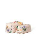 Beige floral makeup bag matching set, pink lining, beige zippers, and decorative tassel.