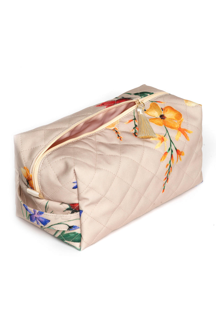 Large beige floral makeup bag opened to show pink polyester lining and spacious interior
