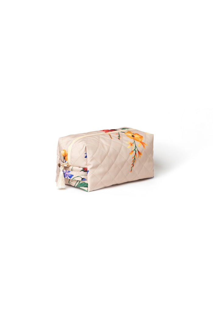Large beige floral cosmetic bag with beige zipper closure and decorative tassel detail