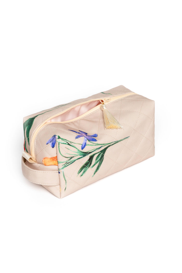 Small beige floral makeup pouch opened to reveal pink lining and compact storage for beauty essentials