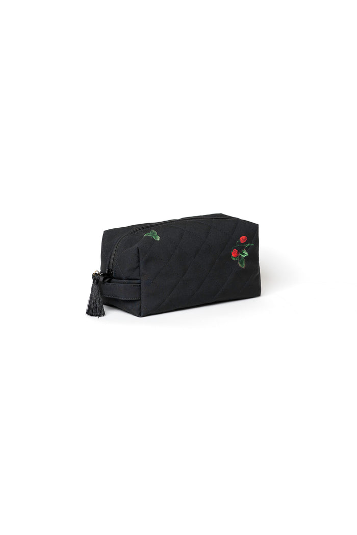 Small black cosmetic bag with strawberry print, black zipper, and tassel detail for makeup, skincare, and travel accessories