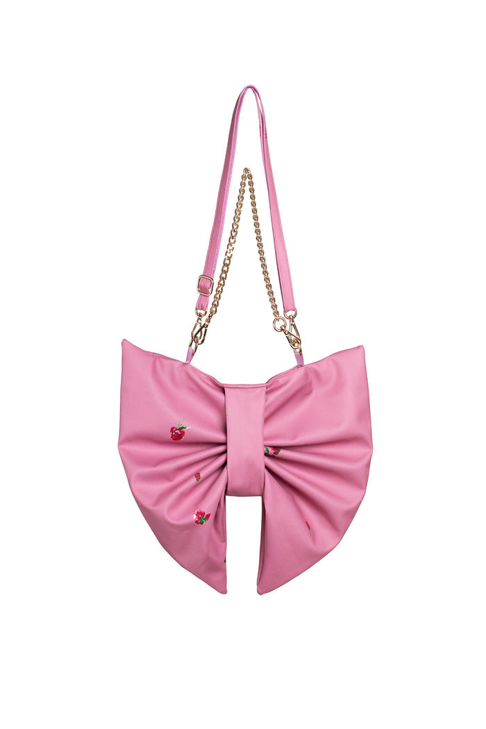 Pink bow-shaped handbag with a chain strap on a white background