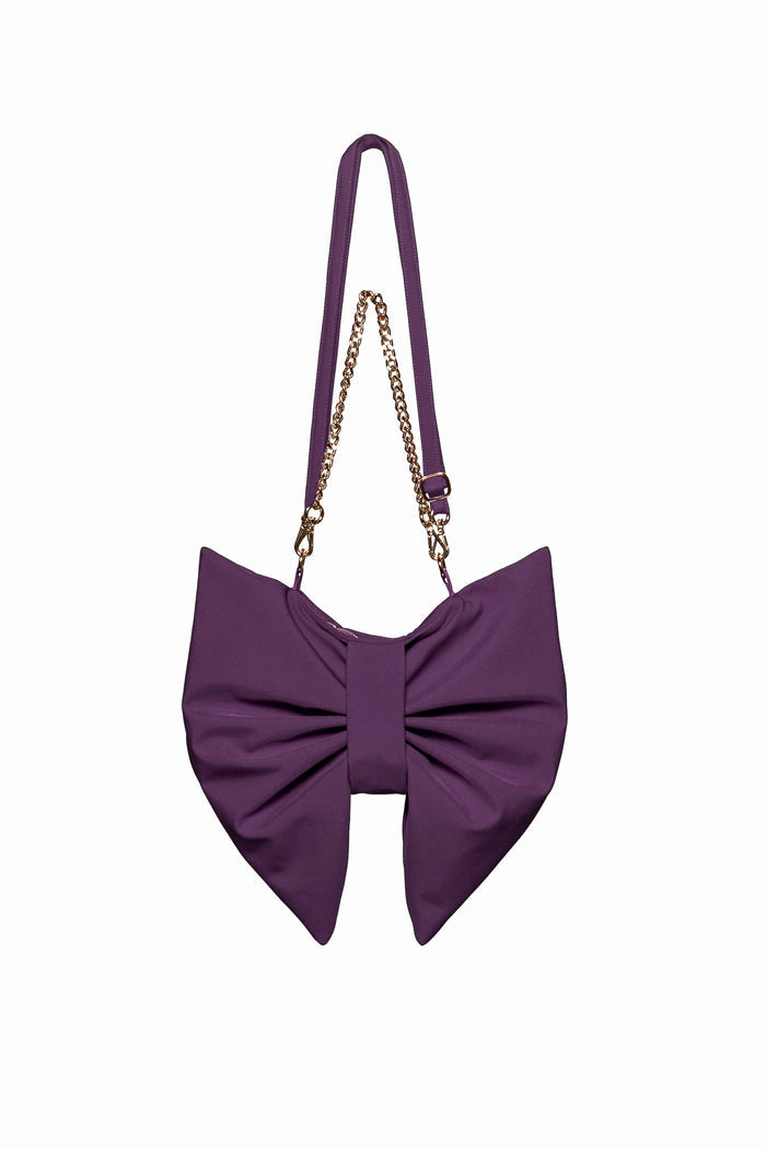 Purple bow-shaped handbag with a chain strap on a white background