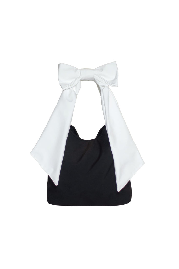 Black Moonlight tote bag with white shoulder straps and bow detail, durable water-resistant fabric.