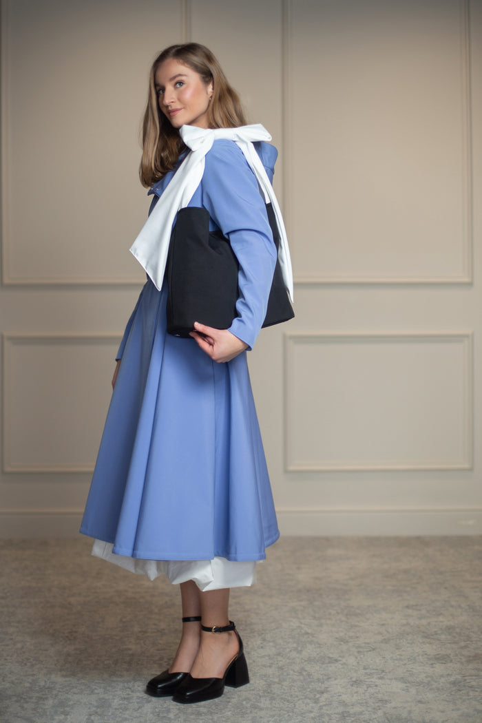 Chic black bow tote bag, perfectly paired with the Blue Breeze coat; adds sophistication and structure to any outfit.