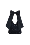 Black tote bag with bow detail and white polka dot print on a white background