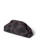 A dark brown and black floral patterned clutch bag, photographed from an angle on a clean white background.