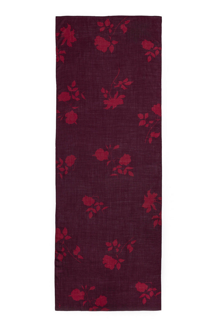 A rectangular burgundy wool and silk scarf with a subtle floral pattern, displayed flat against a solid white background.