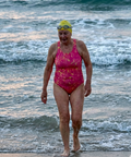 Athlete wearing a pink sustainable one-piece swimsuit with fixed straps for pool training and water sports.