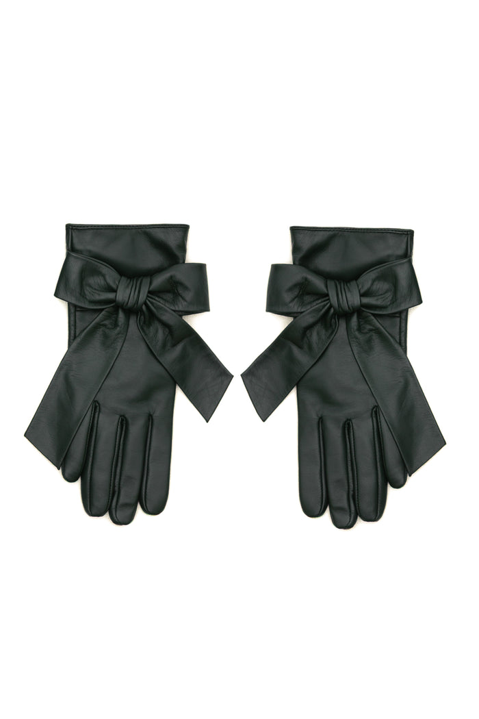 A pair of deep green leather gloves with wide cuffs and large bow details, displayed flat against a white background.