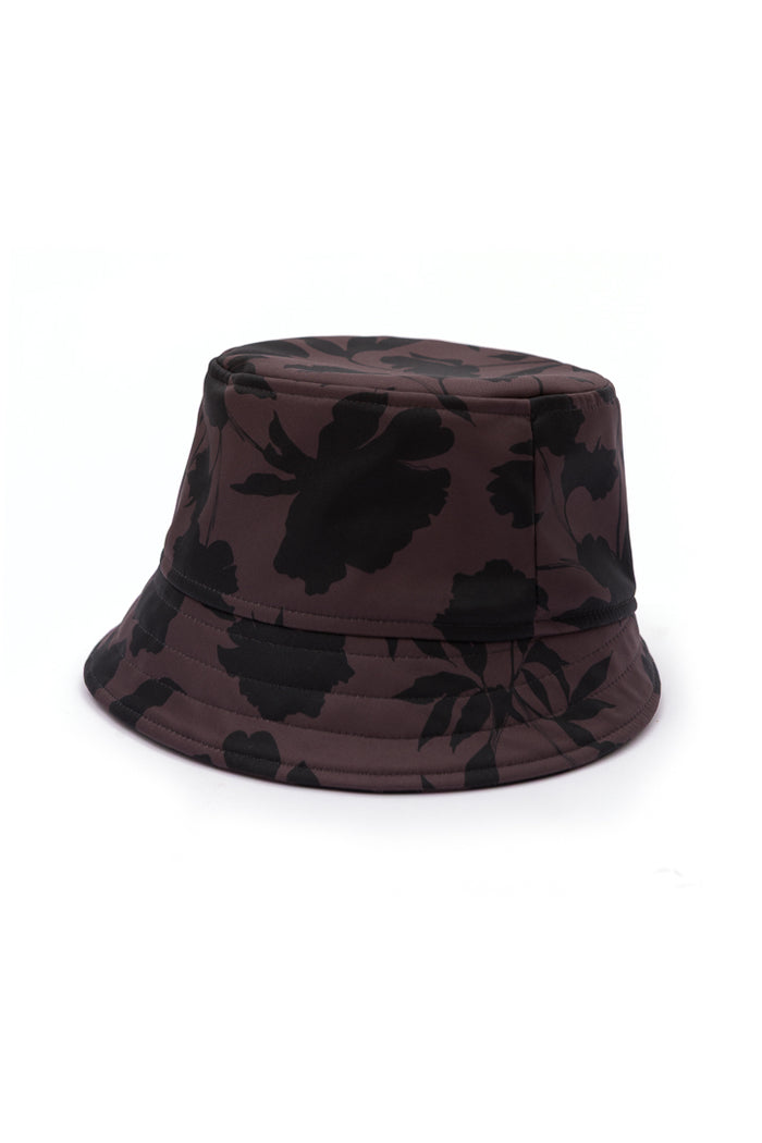 Women's brown floral bucket hat in water-resistant softshell fabric with an elegant black floral print and soft cotton lining.