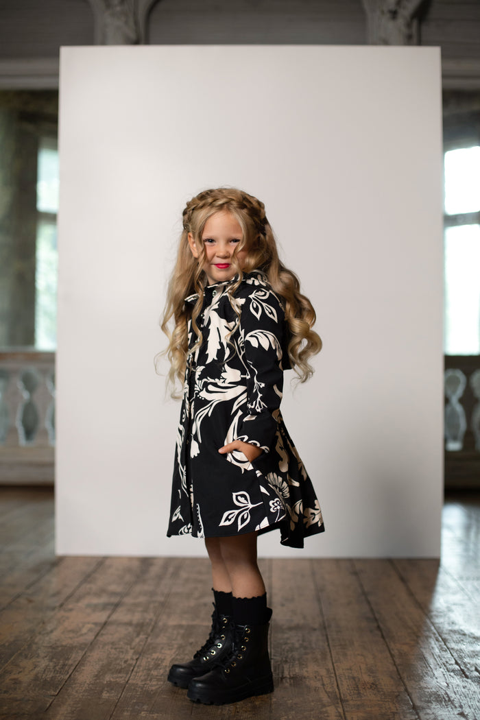 Fitted and Flared Raincoat for girls in black and white color with pleated back