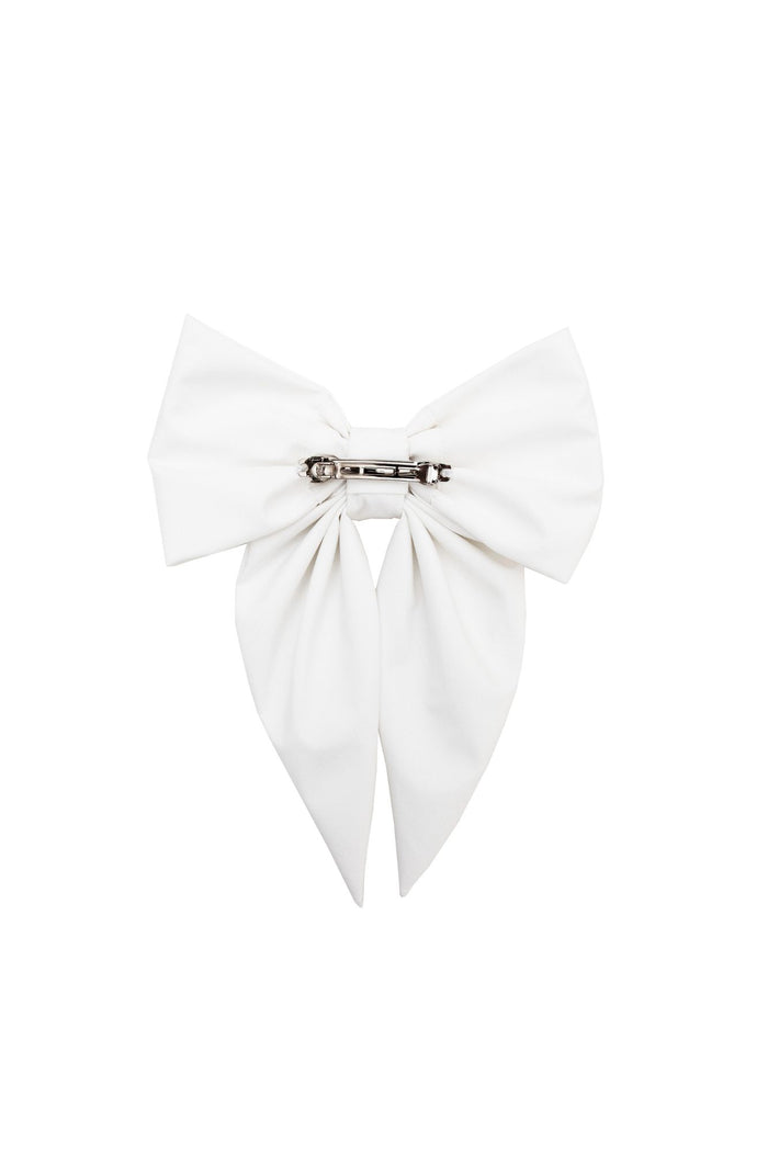 White bow-shaped hair accessory on a white background