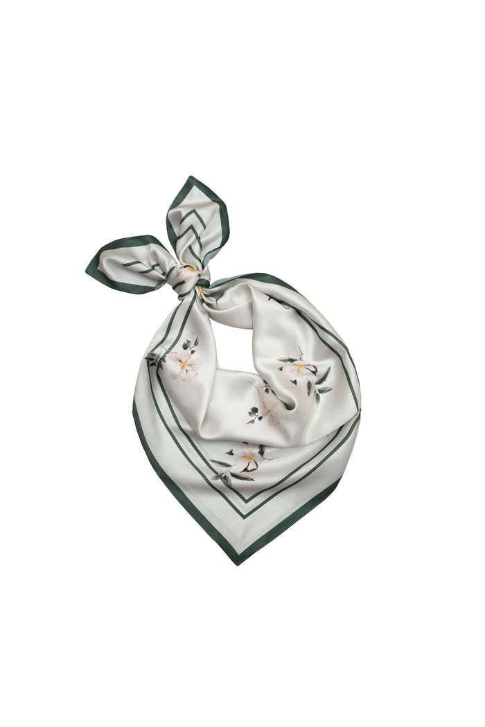 Neatly folded scarf with floral pattern on a white background