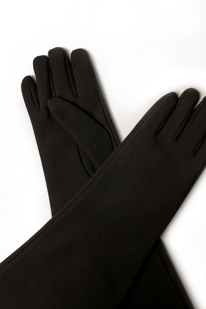 A pair of long black softshell gloves laid crossed over each other on a plain white background.