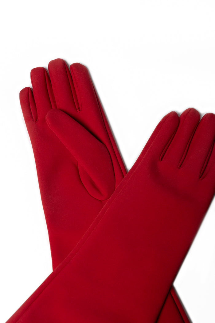 A pair of long, smooth softshell waterproof gloves in a red color, arranged in a crossed pattern on a plain white background.