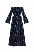 A navy blue off-the-shoulder maxi dress with long bell sleeves, featuring a delicate blue and yellow floral pattern and a tie waist, shown against a plain white background.