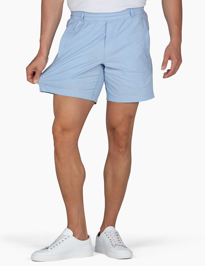 birddogs-baby-blue-oxford-shorts-on-model-front-stretching
