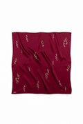 Red fabric with small floral patterns on a white background