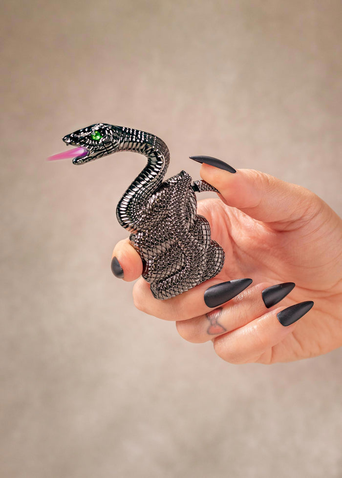 hand holding snake shaped lighter with pink flame