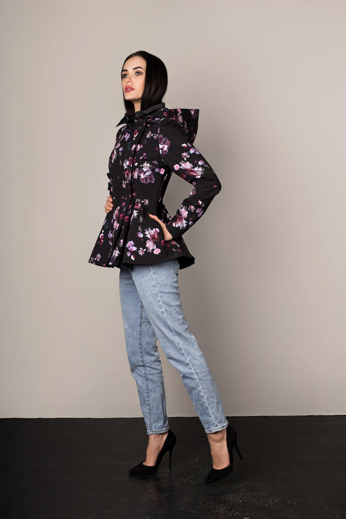 Side view of black floral women's peplum jacket with fitted waist and flared hem, showing silhouette shape